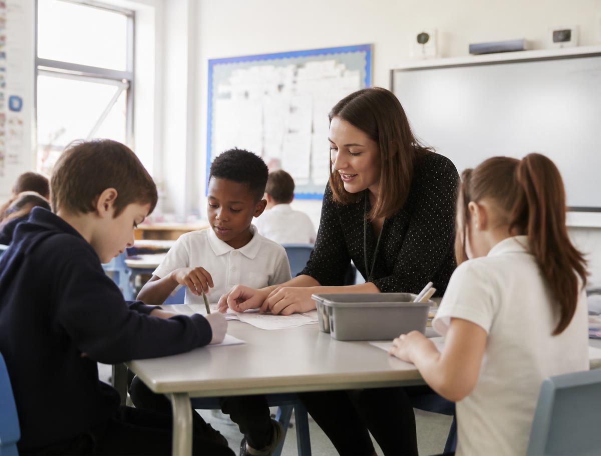 An instructor working with a small group of adult learners
